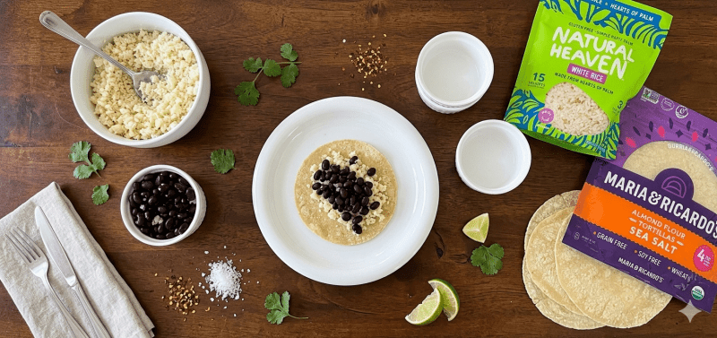Overhead shot of a flour tortilla with hearts of palm white rice and black beans
