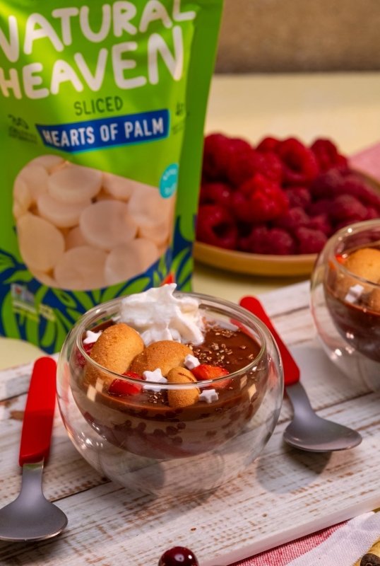 Creamy chocolate mousse made from hearts of palm blended with dark chocolate, served chilled with whipped cream and berries.