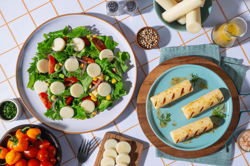 Green salad with sliced hearts of palm on top. Grilled hearts of palm on the side